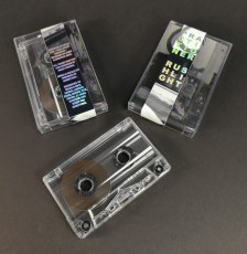 Clear prison cassette tapes in cases with J-cards and holographic foil obi strips