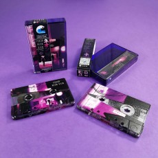 Silver glitter cassettes with a custom reveal on-body print, packed in purple back cases with obi strips