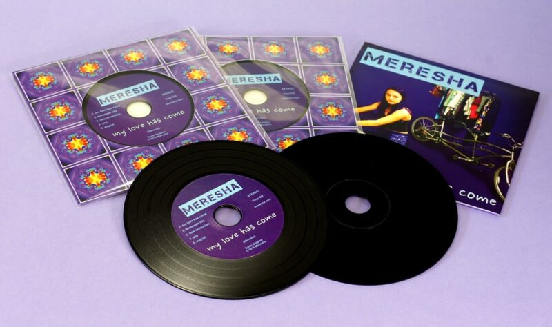 Black vinyl CDs in record-style card wallets with a cellophane wrap